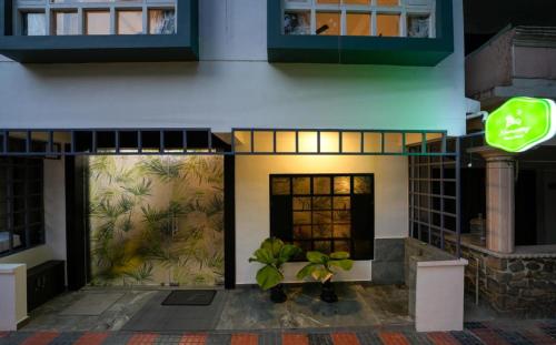 a facade of a building with plants in front of it at Namastay Leisure Homes in Kovalam