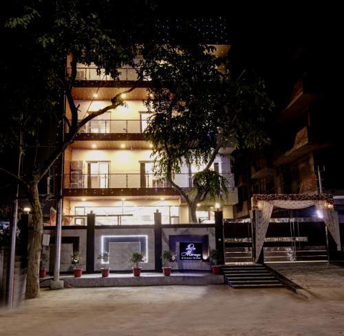 a building with a fireplace in front of it at night at Hotel La Mirage in Noida