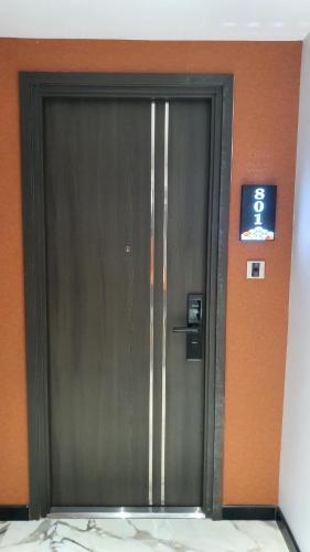 a metal door in a building with a sign on it at MOMIZI HANOI 2 - PHAN KE BINH in Hanoi