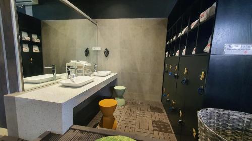 a bathroom with two sinks and a large mirror at MOMIZI HANOI 2 - PHAN KE BINH in Hanoi