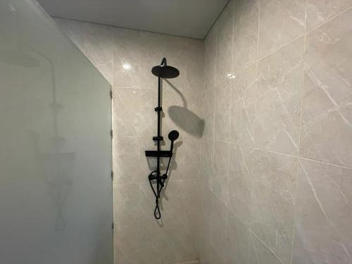 a shower with a light fixture in a bathroom at Villa Rose 1 Sanur in Sanur