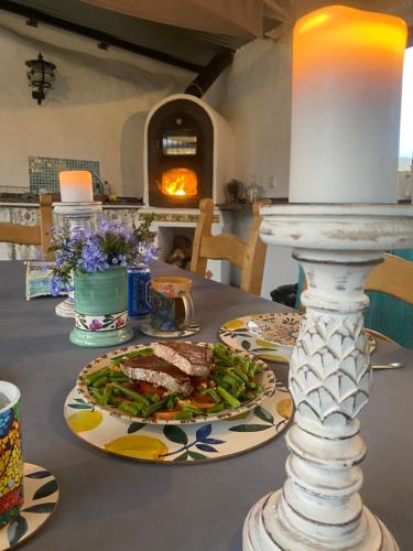 a table with a plate of food on a table at A tranquil mountain escape, casa particular, exclusive accommodation, private pool and terraces in Oria
