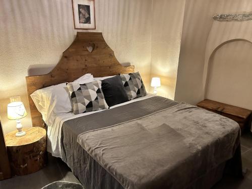 a bedroom with a large bed with a wooden headboard at La casa sul fiume in Oulx