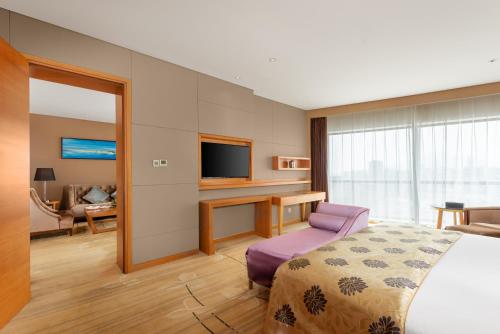 Ένα ή περισσότερα κρεβάτια σε δωμάτιο στο Wyndham Putian Downtown