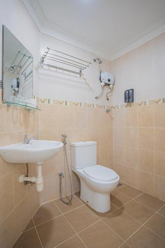 a bathroom with a toilet and a sink at Hotel 28 Titiwangsa in Kuala Lumpur