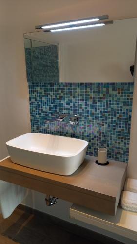 a bathroom with a white sink and a mirror at Home Sweet Home in Pessano con Bornago