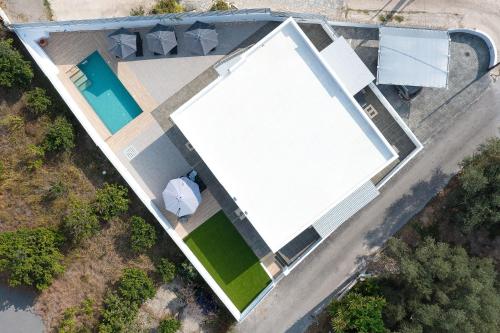 an overhead view of a large white building with a pool at Olea Villa in Archipolis