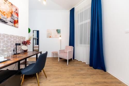 a dining room with a table and chairs at Adagio Downtown Rooms in Budapest