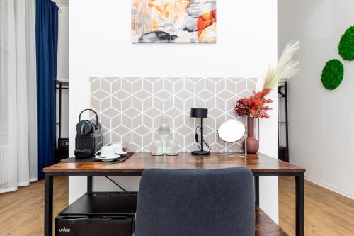 a wooden table with a vase of flowers on it at Adagio Downtown Rooms in Budapest