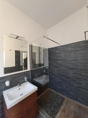 a bathroom with a sink and a mirror at Residence del Centro in Modena