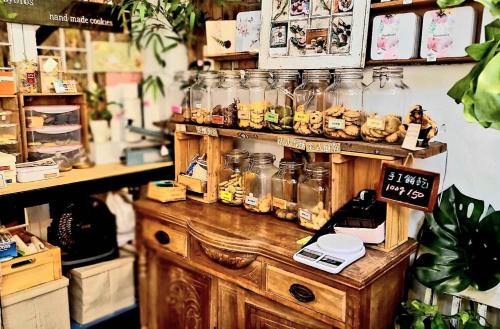 a store with jars of food on a wooden table at Huabing in Tainan