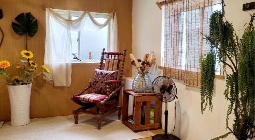 a room with a rocking chair and a window at Huabing in Tainan