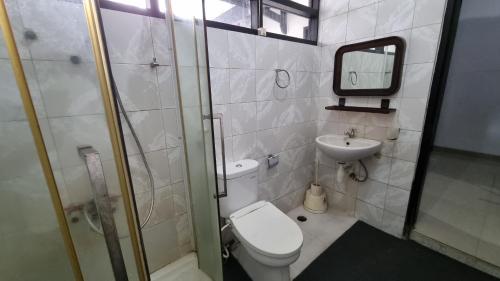 a small bathroom with a toilet and a sink at WKNDR Zone in Jakarta