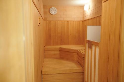 a walk in sauna with a clock on the wall at Umekoji Potel KYOTO in Kyoto
