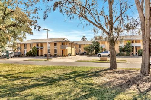 a building with a tree in front of it at Heart of Henley - A Homey Hideaway by the Beach in Adelaide