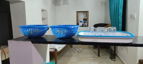 three blue bowls are sitting on a table at Raagabynature home stay in Gendehalli
