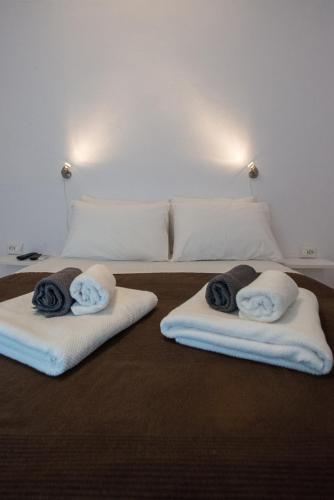 a bedroom with two towels on a bed at Corrado Caldera Apartments in Fira