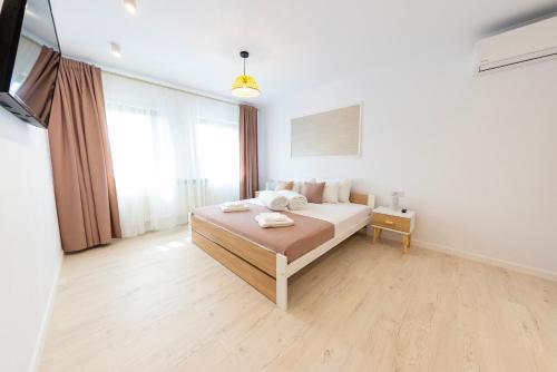 a bedroom with a bed and a large window at Casa cu Nuc in Alba Iulia