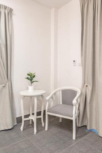 a table and two chairs and a table and a potted plant at Apple Villas in Haad Chao Phao
