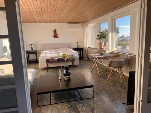 a bedroom with a bed and a table in a room at Sea view nordic design apartment near beach great for couples in Snekkersten