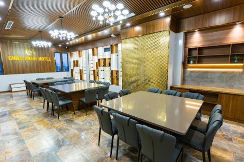 a dining room with tables and chairs and a bar at CM Hotel & Apartment in Hai Phong