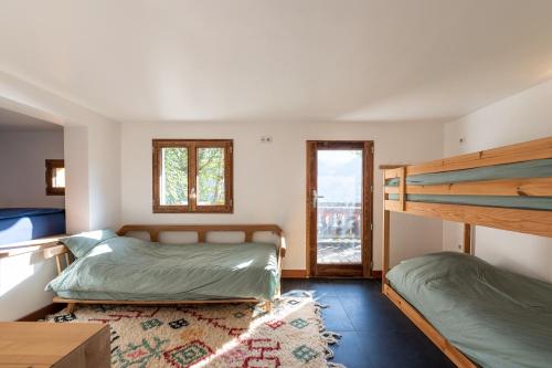 a bedroom with two bunk beds and a window at Le Relief - Maison avec magnifique vue montagne aux Bettex in Saint-Gervais-les-Bains