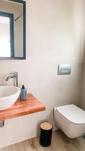 a bathroom with a sink and a toilet at ELÉA Guesthouse himare in Himare