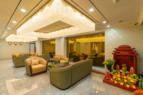 a lobby with couches and chairs and a table at CM Hotel & Apartment in Hai Phong