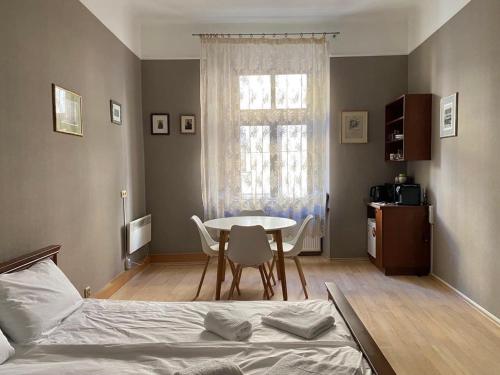a bedroom with a bed and a table and chairs at Freska Apartments in Lviv