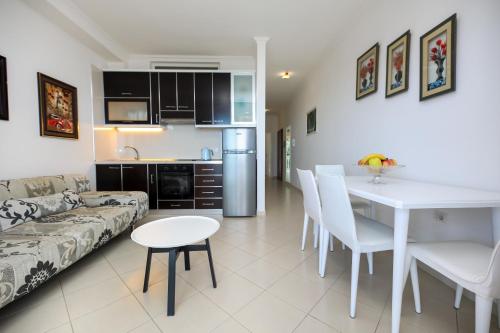 a kitchen and living room with a couch and a table at Rezidenca Panorama Apartments in Vlorë