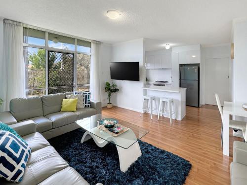a living room with a couch and a table at Captain's Rest - Seaside Lifestyle on West Beach in Adelaide