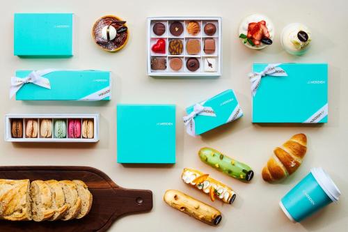 a table with blue boxes and bread and pastries at Le Meridien Seoul Myeongdong in Seoul