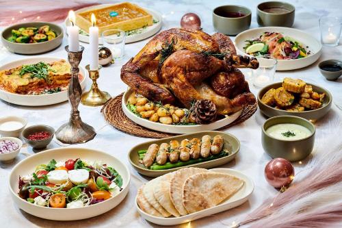 a table with a turkey and many plates of food at Le Meridien Seoul Myeongdong in Seoul