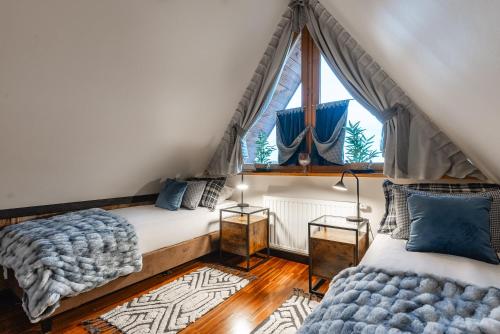 a bedroom with a bed and a window at Apartament Aspekt Zakopane in Zakopane
