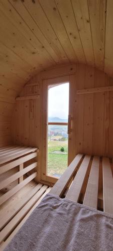 a wooden room with a bed and a window at Szczytowisko in Grywałd