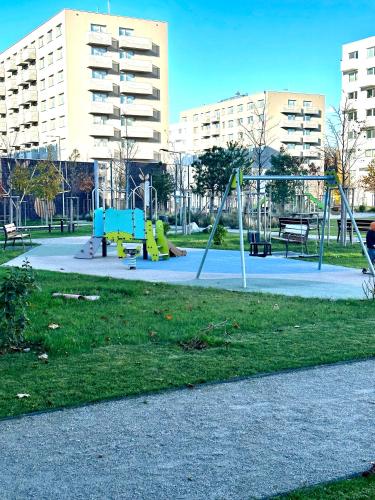 a park with playground equipment in a city at Apartmán s klimatizáciou a balkónom pri letisku BTS in Bratislava