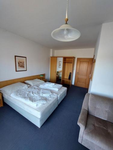 a bedroom with two beds and a couch at Pension Schager 