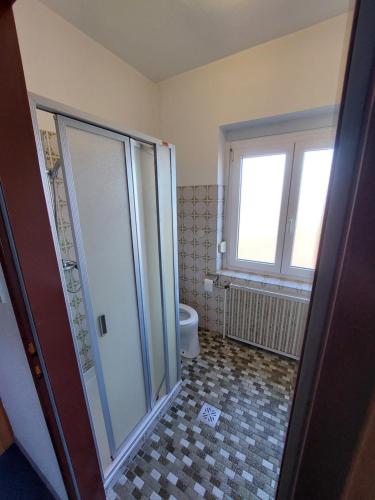 a bathroom with a shower and a toilet at Pension Schager 