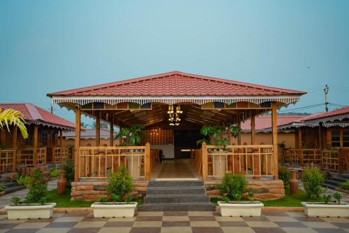 a building with a pavilion with a staircase in front at Grace Exotica Goa in Canaguinim