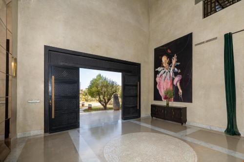 a door in a room with a painting on the wall at Fellah Hotel in Marrakech