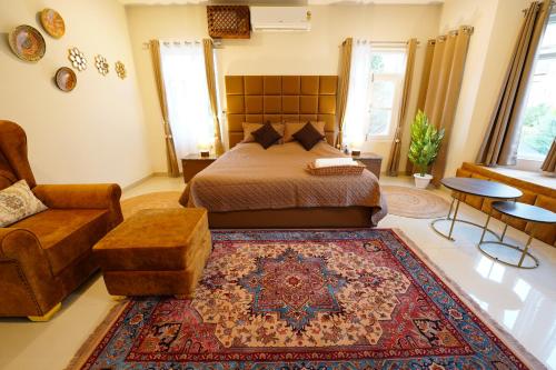 a bedroom with a bed and a chair and a rug at Walisons Homestay Spirea in Srinagar