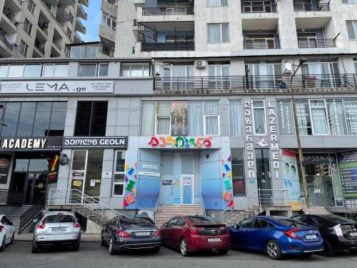 a group of cars parked in front of a building at HOTEL AMSTERDAM in Batumi