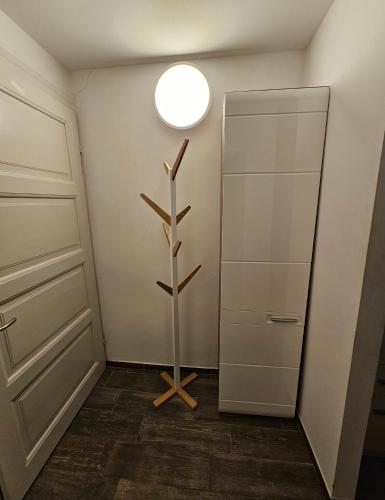 a room with a closet with a shelf and a light at Soba 7 Pekrska vila in Limbuš