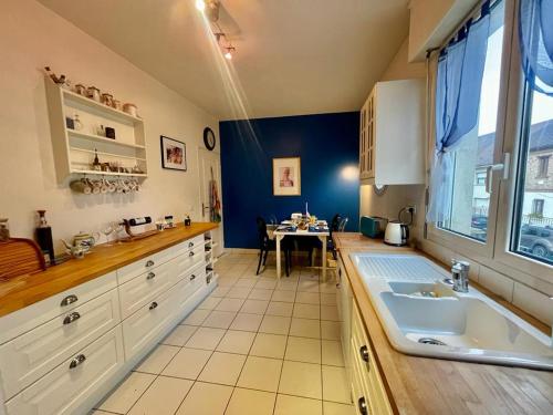 a kitchen with a sink and a table in it at Paris & Versailles at your feet! Shared room in nice house in Meudon