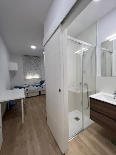 a white bathroom with a shower and a sink at Colegio Mayor Careu - Women Only - University Community in Seville