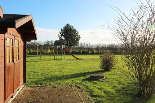 a yard with a playground with a swing at Fewo Peeneblick 5_LIND in Ostseebad Karlshagen