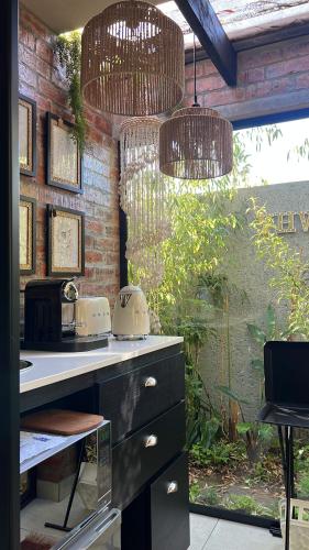 a kitchen with a counter with two toasters on it at The Secret Garden Hideaway in Mossel Bay