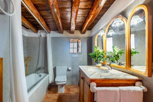 a bathroom with a toilet and a tub and a sink at New! Villa Na Ribes in Sant Carles de Peralta