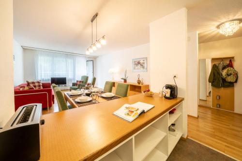 a room with a kitchen and a living room at Chasa Plavna in Vulpera