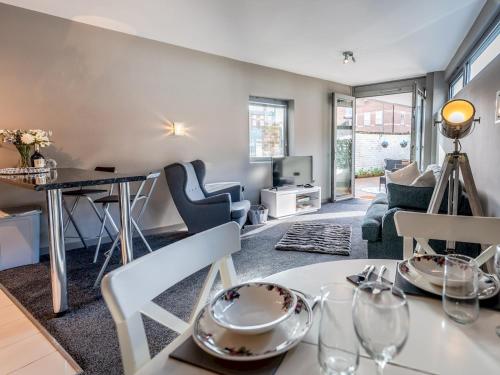 a living room with a table and chairs at Modern flat a short walk from Shrewsbury centre - Pass the Keys in Shrewsbury